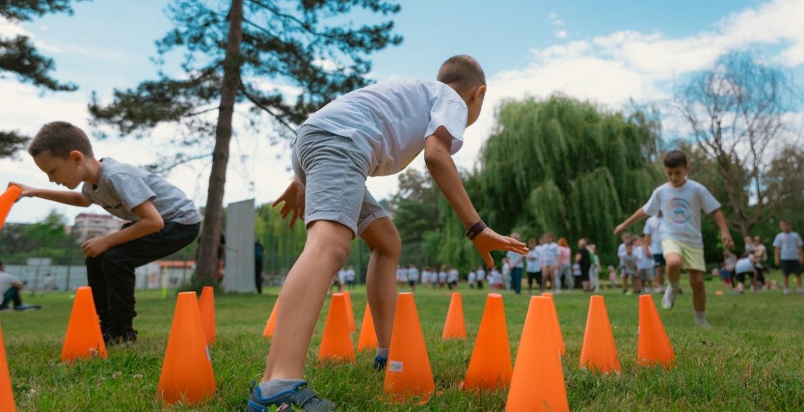 Group of kids enjoying exercise and play at a park obstacle course.