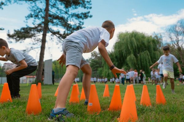 Group of kids enjoying exercise and play at a park obstacle course.
